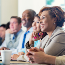 Professionals listening during a conference.