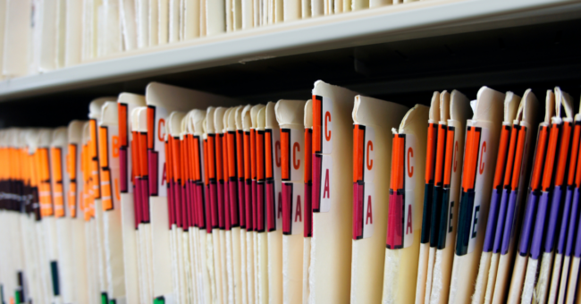 alphabetized, color-coded files on a shelf